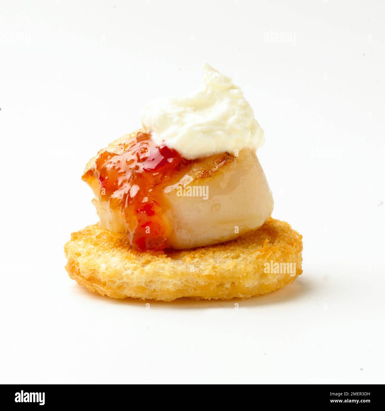 Griddled scallop with sweet chilli sauce and creme fraiche, croute, canape Stock Photo