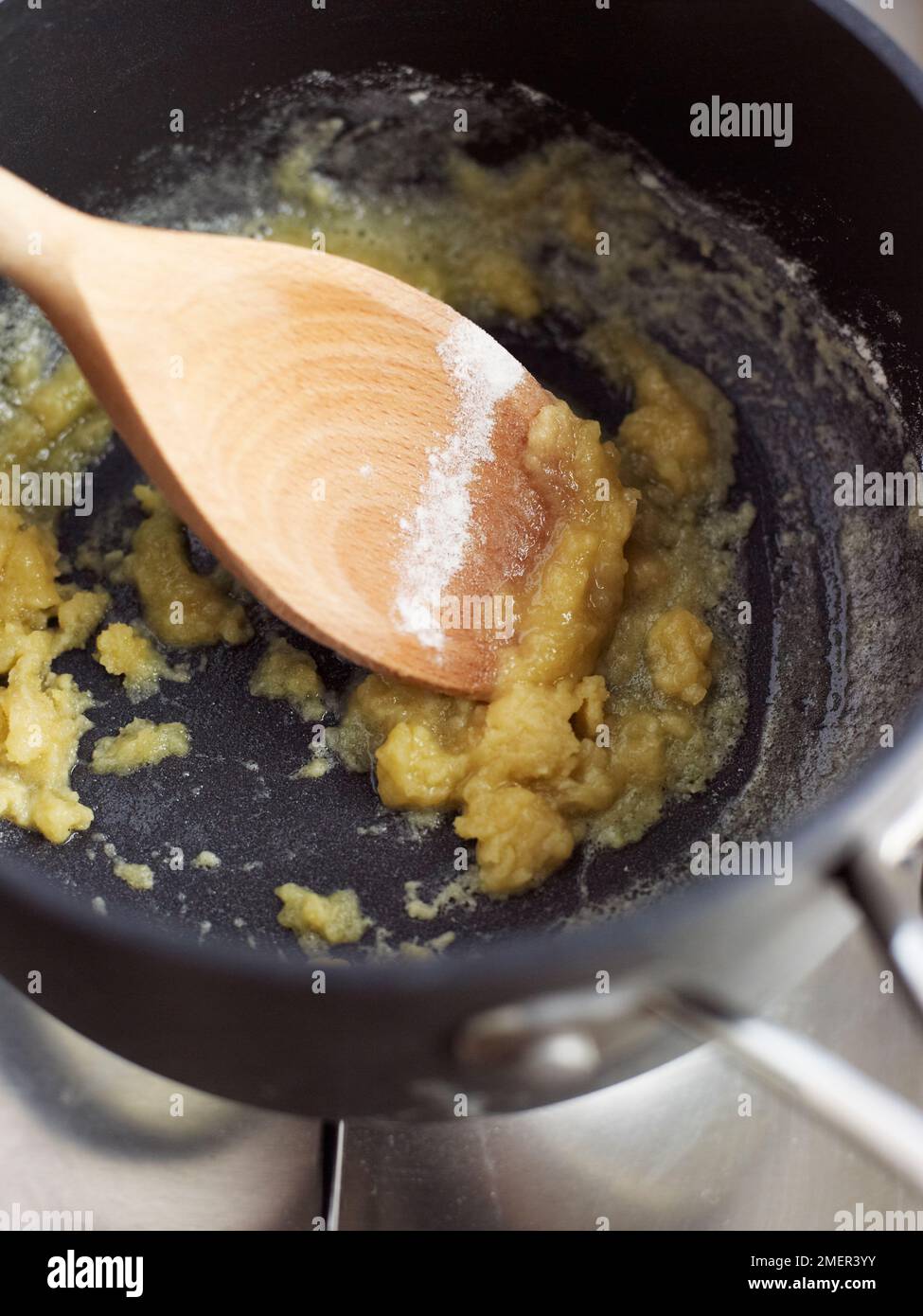 Cooking a roux in heavy-based saucepan (making veloute sauce) Stock Photo