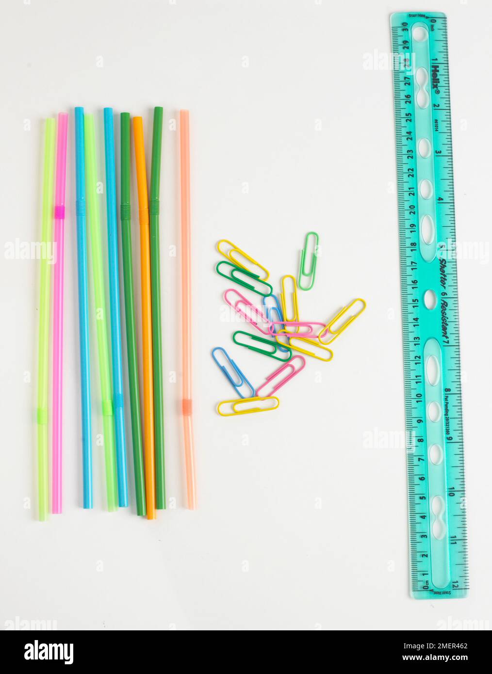 Colourful drinking straws, paper clips, and a ruler Stock Photo