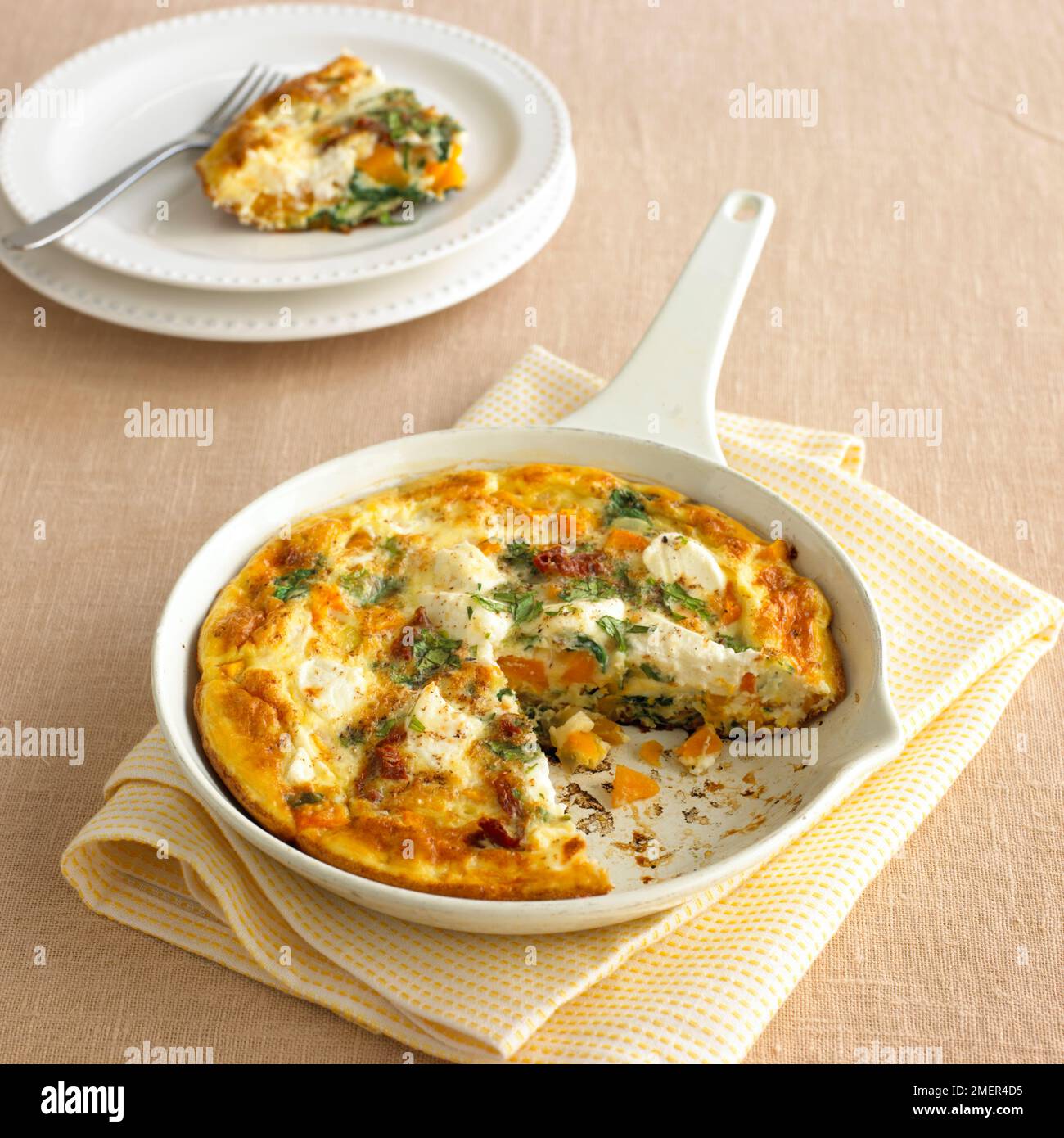 Butternut squash, spinach and goat's cheese frittata in ovenproof pan