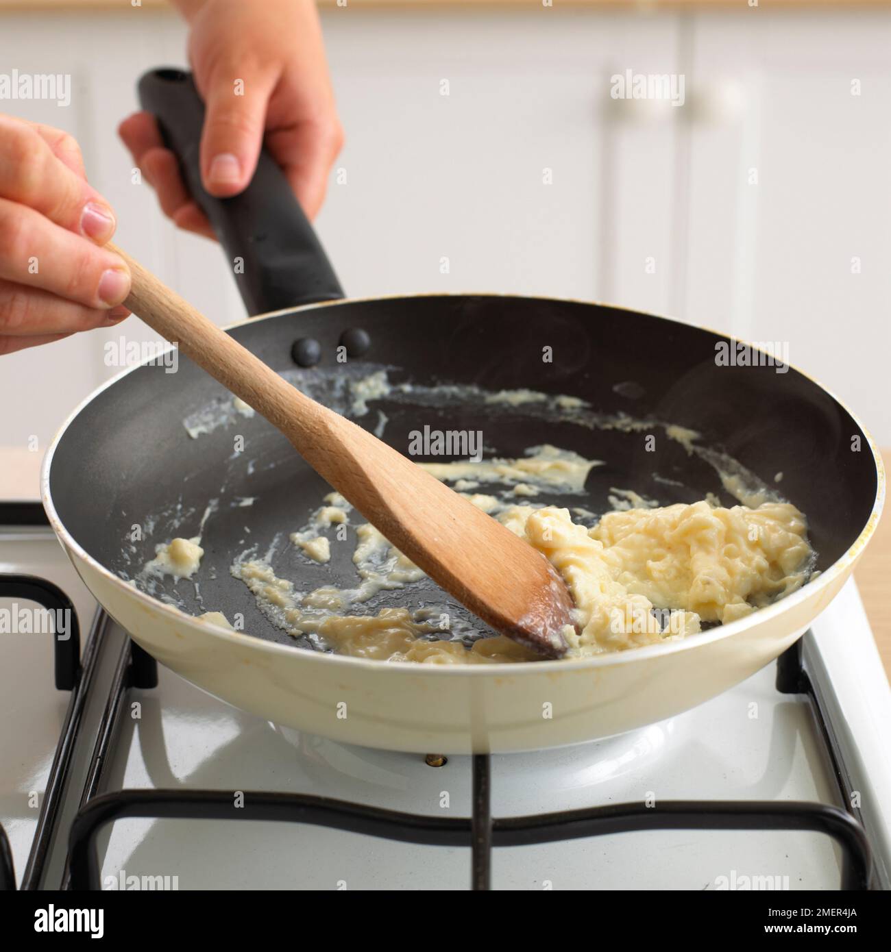 Cooking scrambled eggs in a pan Stock Photo Alamy