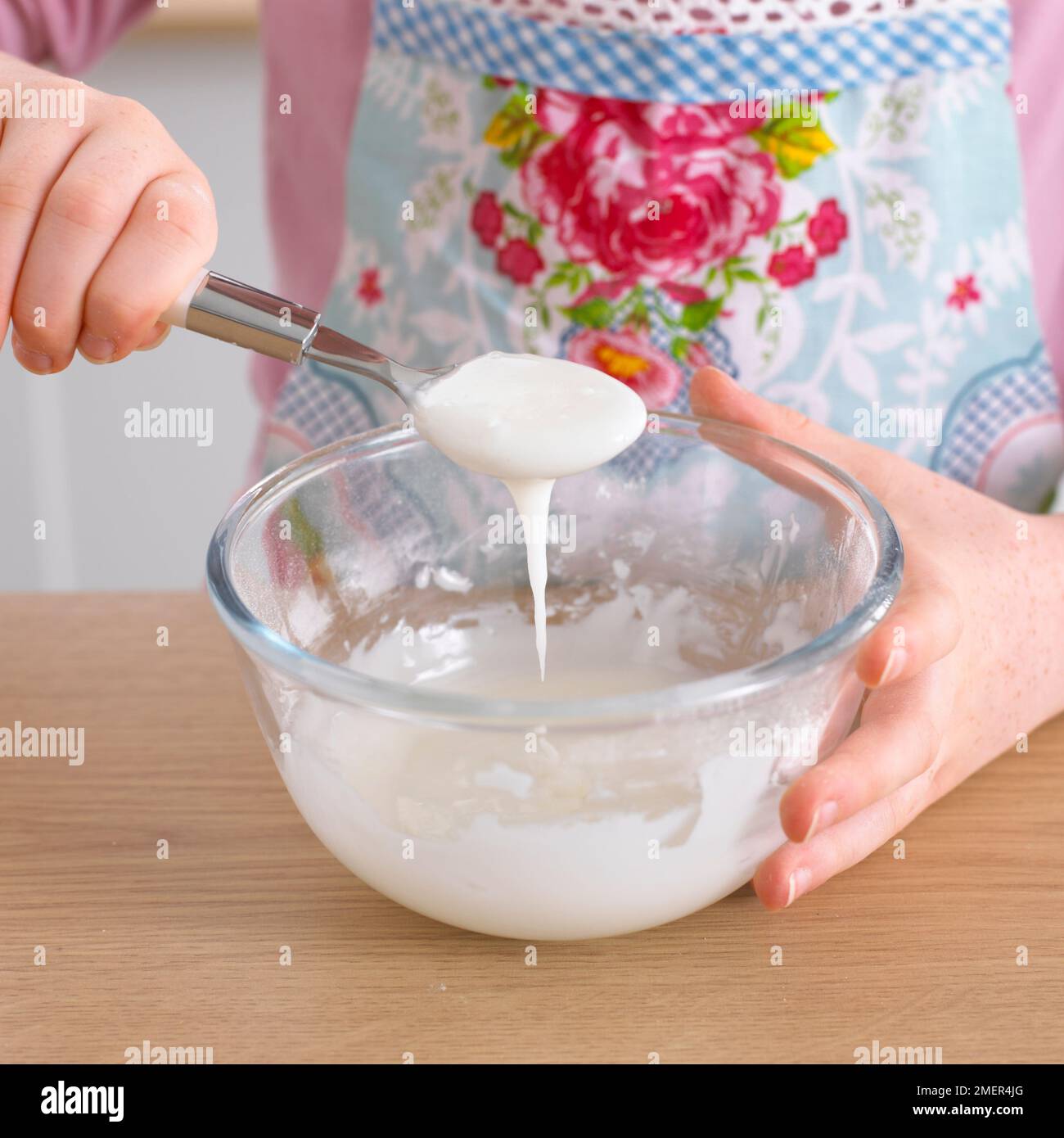 Combining lemon juice and lime juice to icing sugar Stock Photo