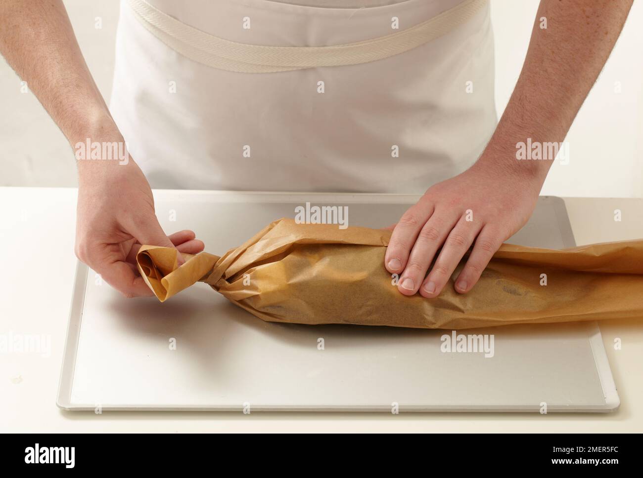 Wrapping sea bream in baking paper Stock Photo Alamy