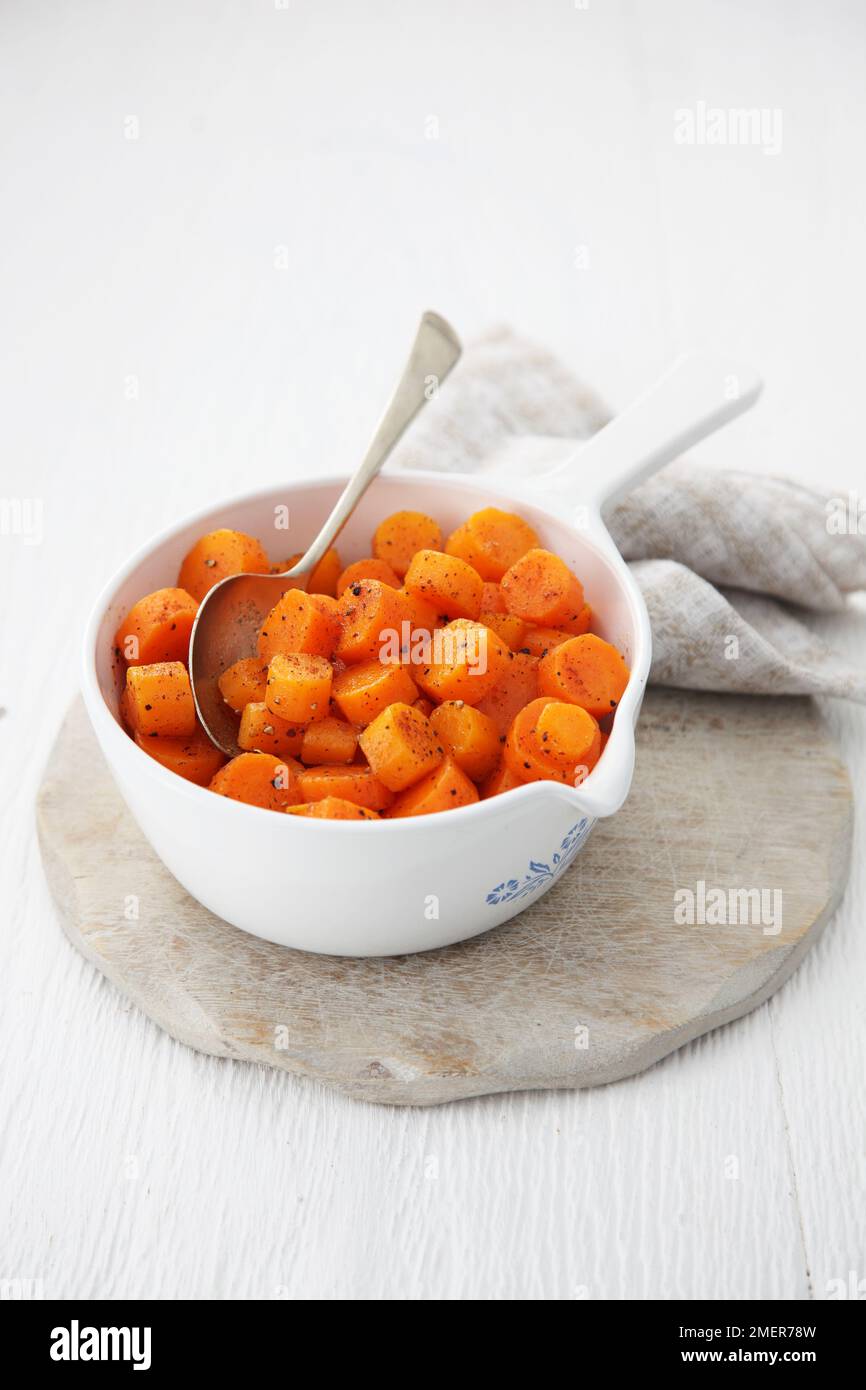 Bowl if glazed carrots and nutmeg Stock Photo Alamy