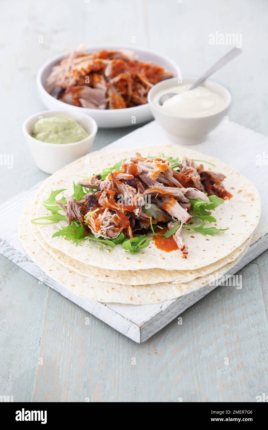 Slowcooked shoulder of pork, wrap, yoghurt and guacamole dip Stock