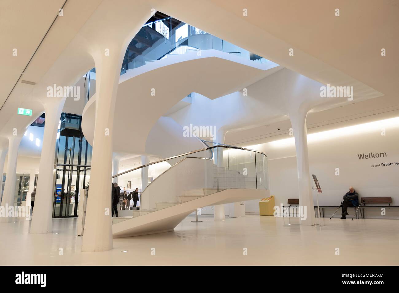 Interior of the hall with columns, information desk, elevator and modern spiral staircase in the underground part of Drents Museum, the Netherlands Stock Photo