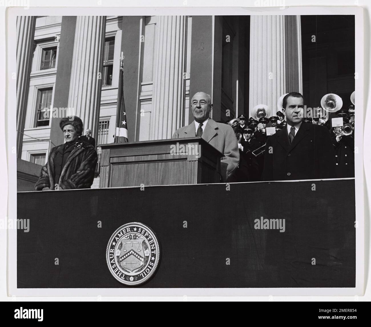 George M. Humphrey and Richard M. Nixon on Opening Day of Alexander Hamilton Bicentennial in Washington, DC. Picture shows George M. Humphrey at podium and Richard Nixon standing to the left of the podium. Stock Photo