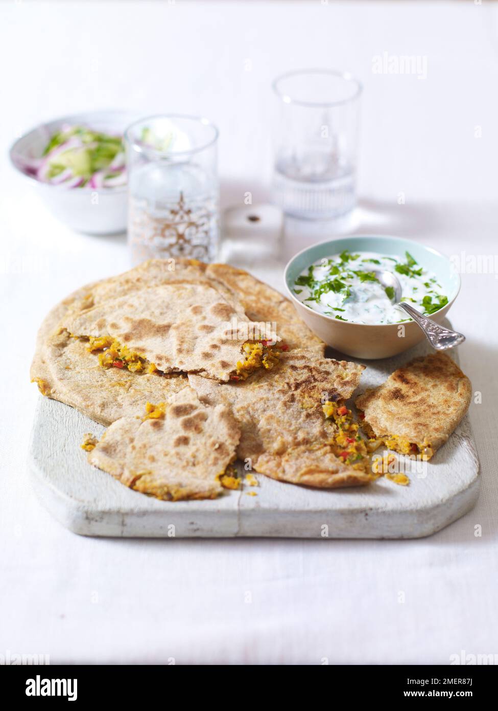 Stuffed indian flat bread, parantha, yoghurt and mint sauce and onion salad Stock Photo Alamy