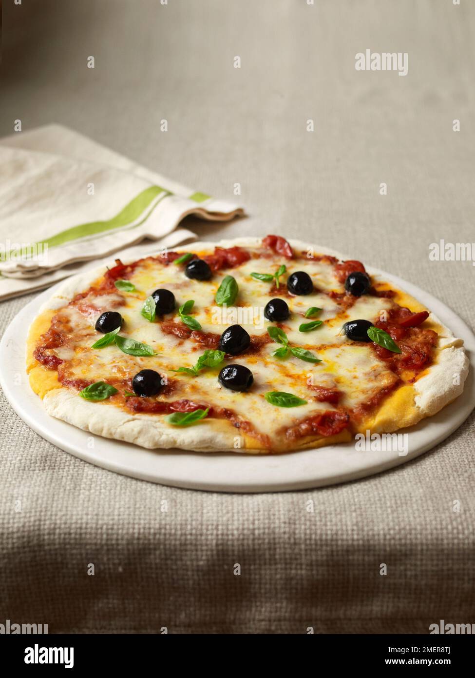 Gluten-free pizza with olives, basil and cheese Stock Photo