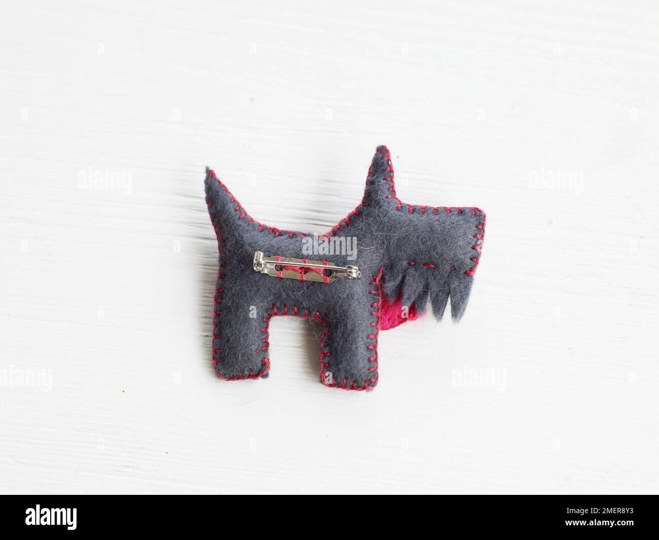 Felt dog badge, brooch pin sewn to back of back Stock Photo