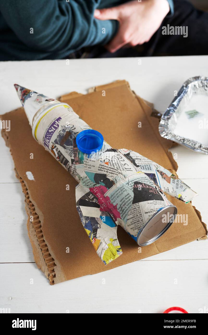 Making rocket pen pot, covering tube with papiermache Stock Photo Alamy