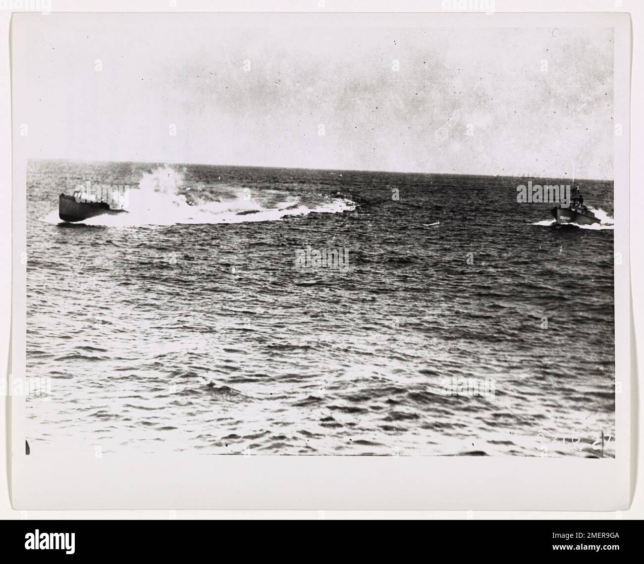 Pursuit of rum-runners. This image depicts a Coast Guard picketboat firing upon a rum-running vessel off the Atlantic coast. Stock Photo