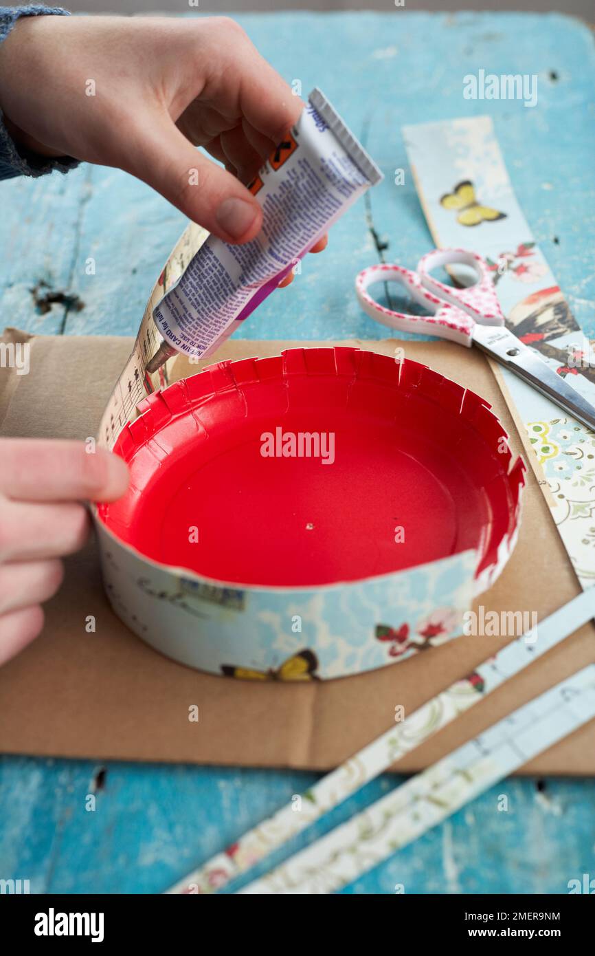 Attaching strips of covered card to outside edge of plate using strong