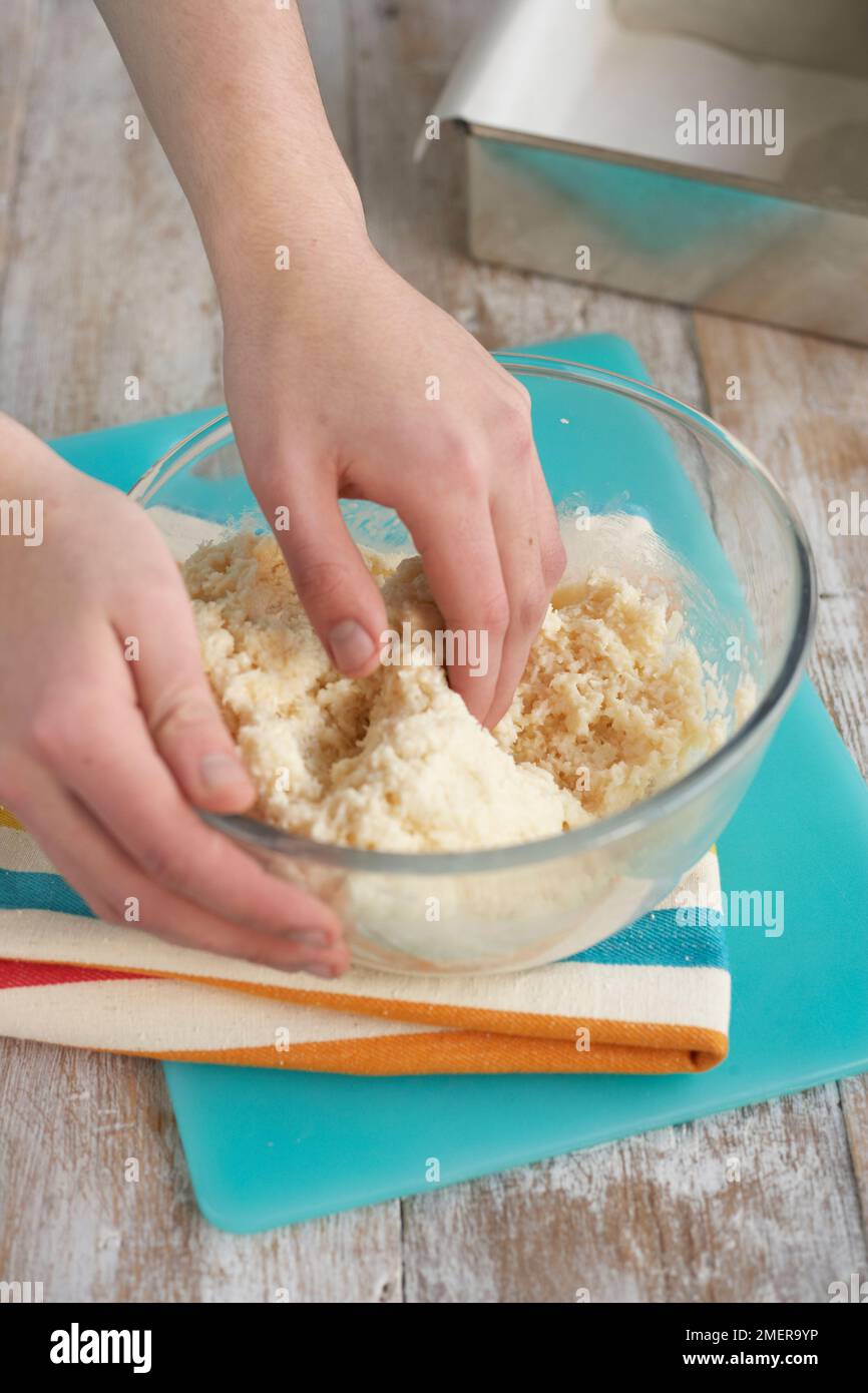 Making coconut bites, mixing desiccated coconut, icing sugar and