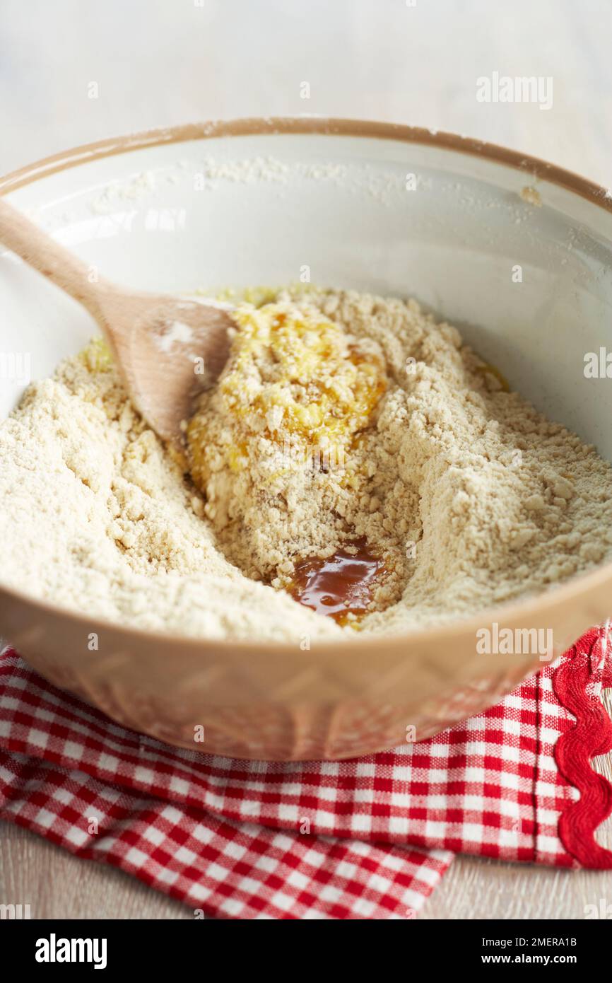 Mixing together gingerbread ingredients, syrup, butter, flour, eggs Stock Photo