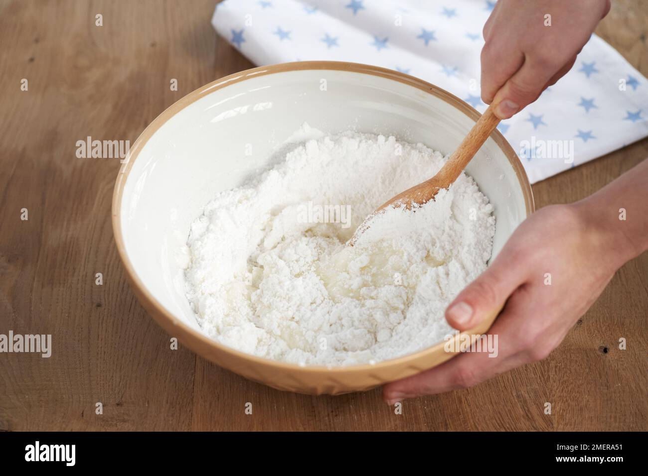 Making piping icing, mixing icing sugar with water Stock Photo Alamy