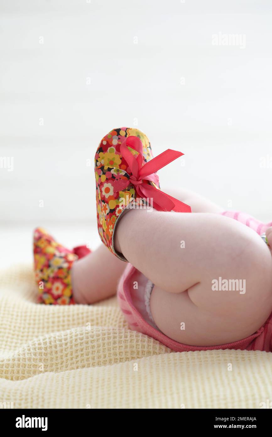 Baby girl wearing booties, 7 months Stock Photo Alamy