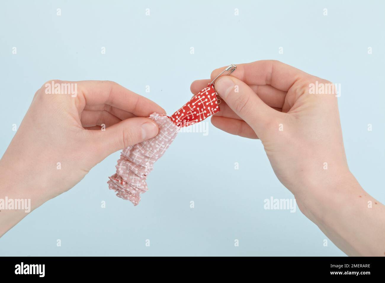 Turn tube of fabric right side out using safety pin, making antislam