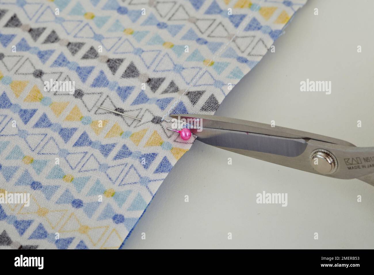 Clip the seam allowance using a scissors, making nappy bag Stock Photo Alamy