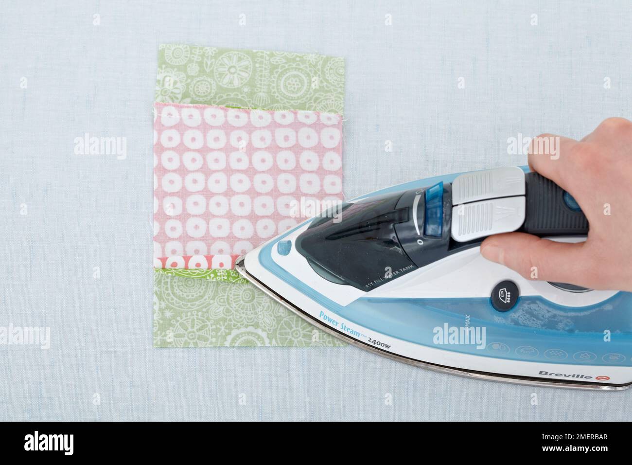 Making a patchwork quilt, press open the seam allowances with an iron