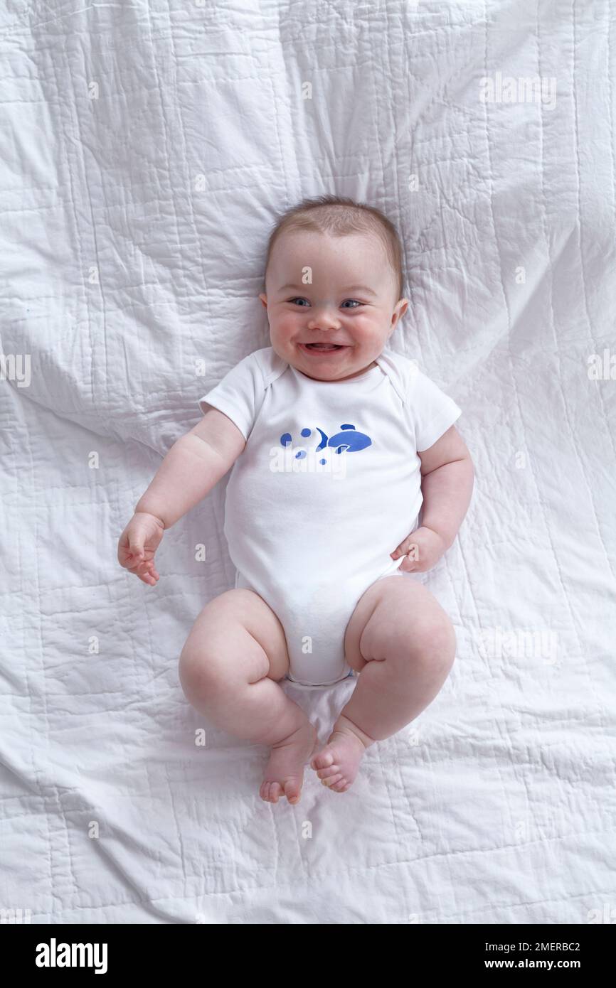 Baby boy, wearing stencilled onesie, 7 months Stock Photo