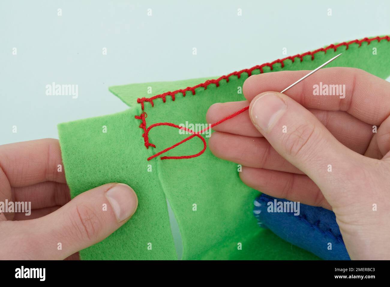 Stacking rings, blanket stitch the edges of toy base Stock Photo Alamy