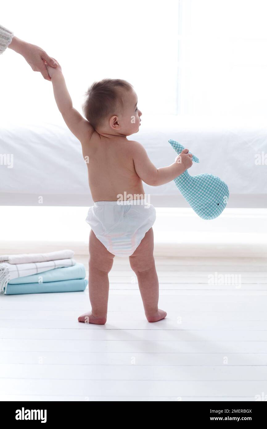 Toddler standing full length diaper boy hi-res stock photography