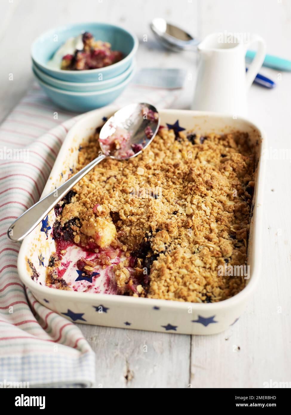 Apple and grape crumble bake in pie dish Stock Photo