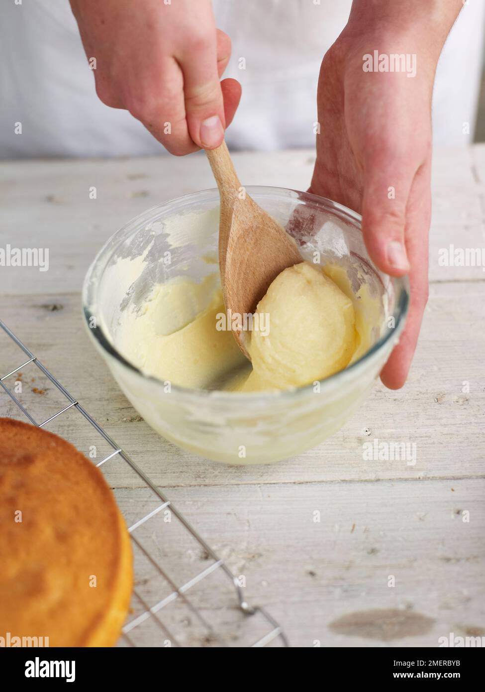 Beating buttercream mixture to make filling for Victoria sponge cake Stock Photo