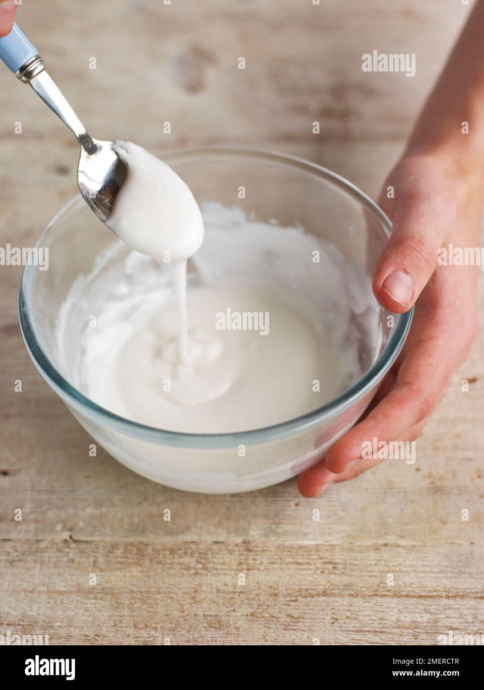 Mixing icing sugar and water in a bowl Stock Photo Alamy