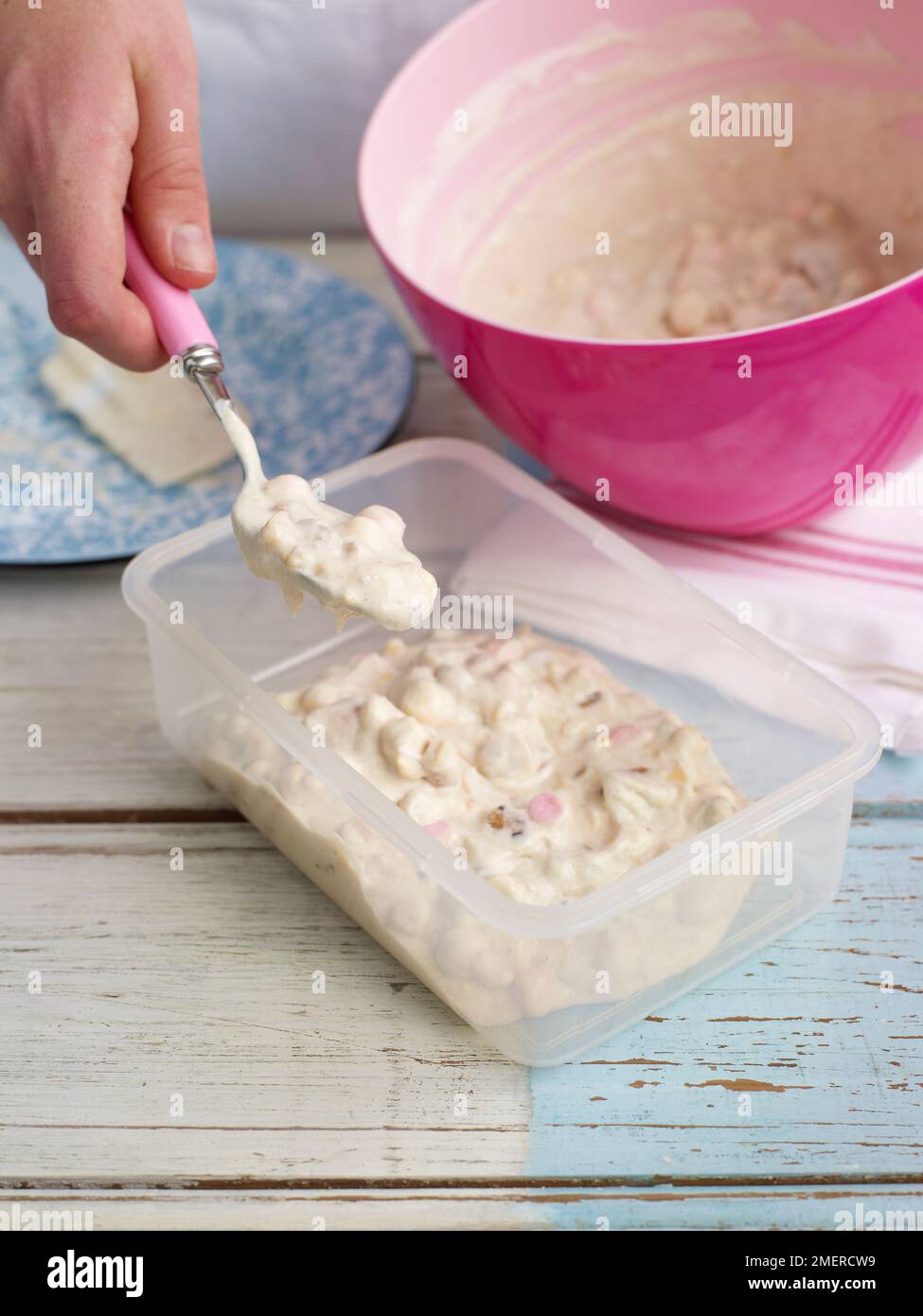 Spooning the cream, and marshmallow mixture from the bowl to