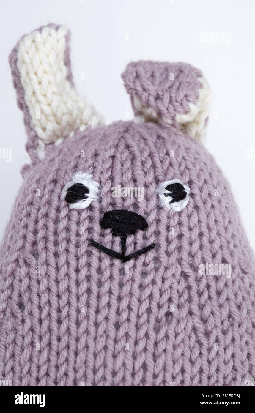 Face of soft knitted rabbit toy Stock Photo