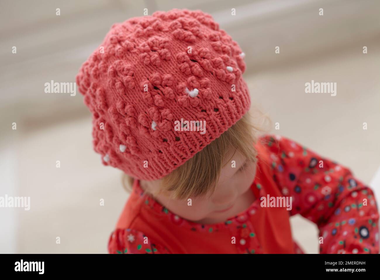 Girl wearing knitted beanie hat, 3.5 years Stock Photo