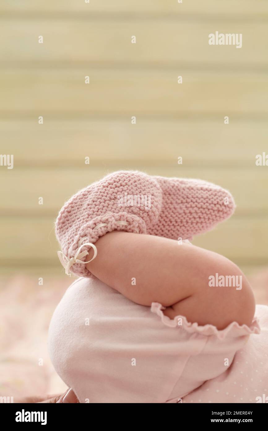 Closeup of pink booties on baby's feet, 6 weeks Stock Photo Alamy