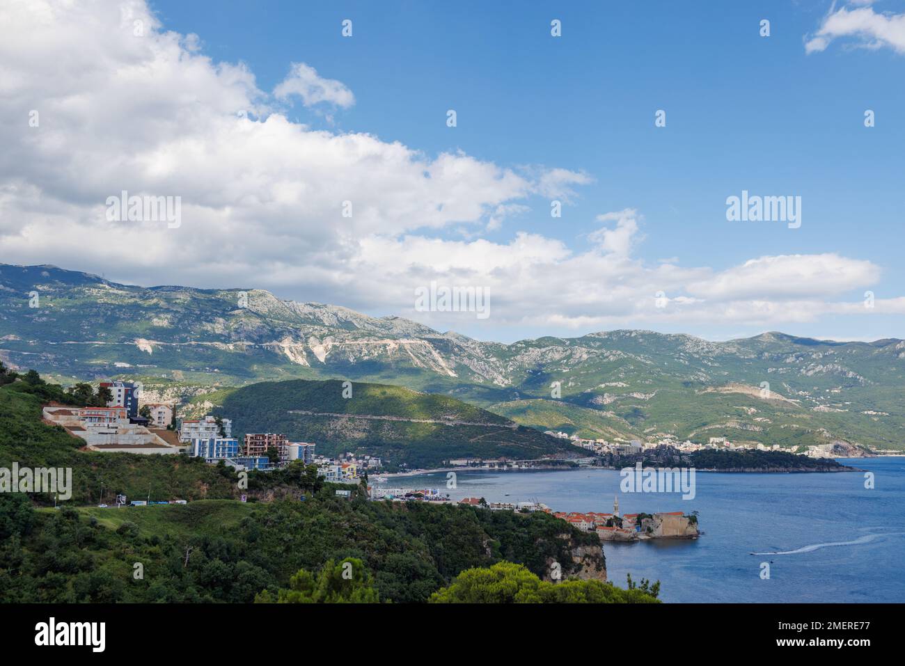 Bird's eye view of historical resort towns of Budva and Becici with luxury hotels and comfortable beaches near azure calm Adriatic Sea against the bac Stock Photo