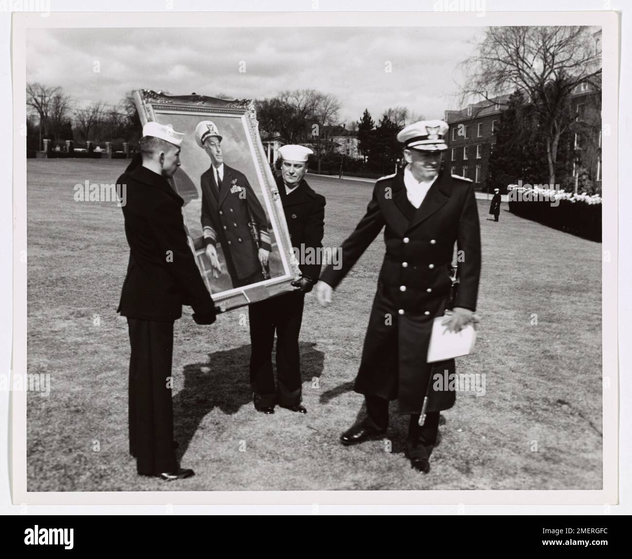 Photograph of Coast Guard Personnel Carrying a Framed Portrait. Stock Photo