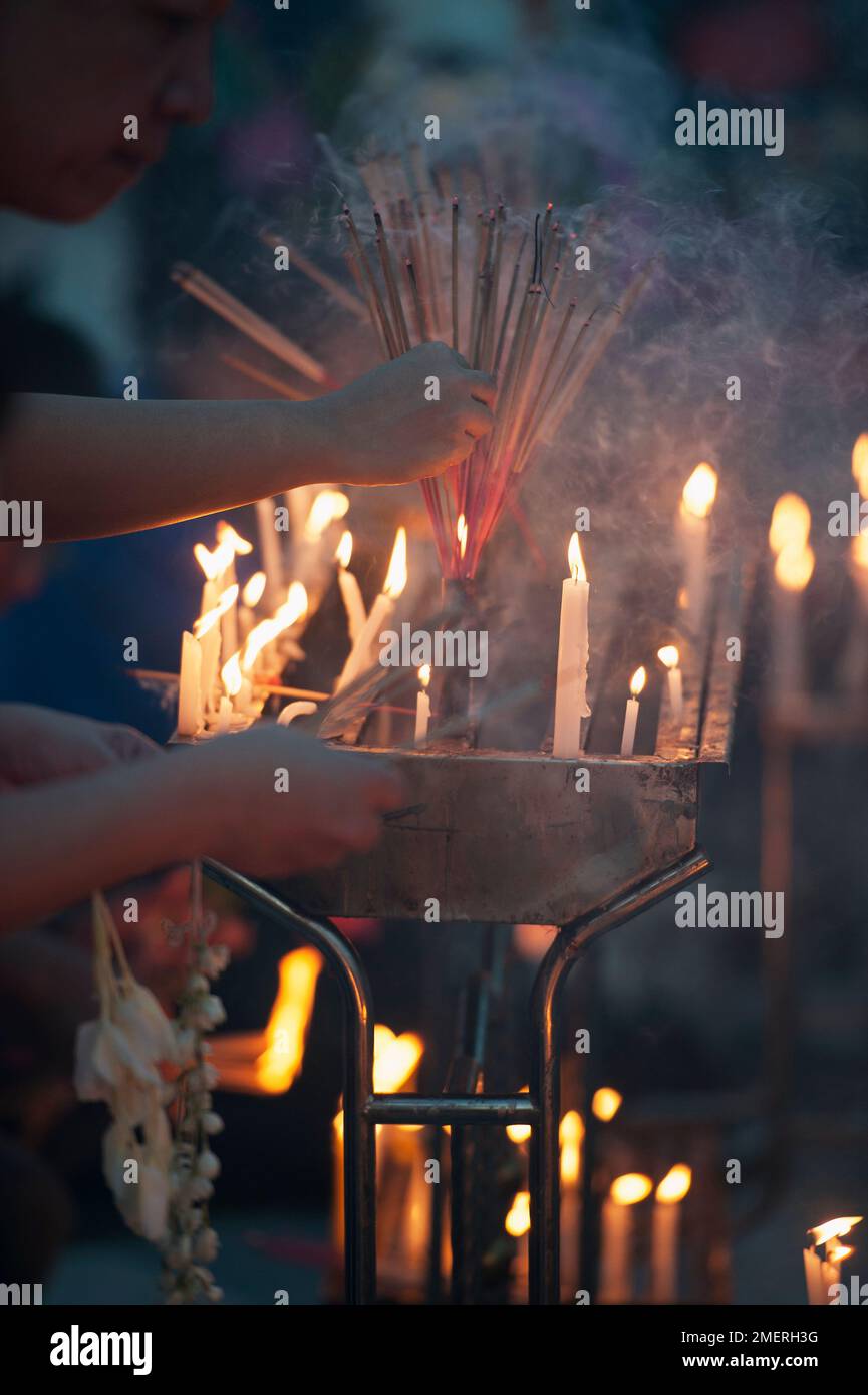 Myanmar, Yangon, Shwedagon Paya, lighting candles and incense sticks in Wish Fulfilling Place Stock Photo