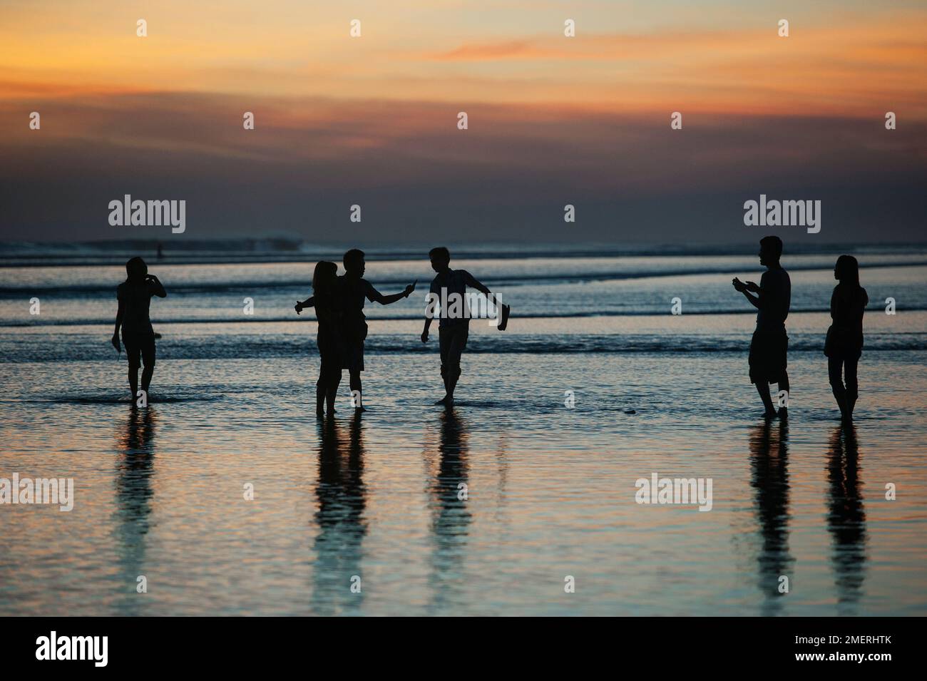 Myanmar, Western Myanmar, Sittwe, young people on beach at sunset Stock Photo