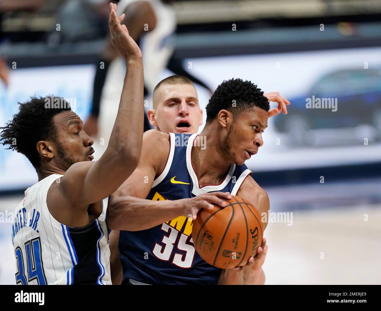 Denver Nuggets guard PJ Dozier, right, pulls in a rebound as Orlando ...