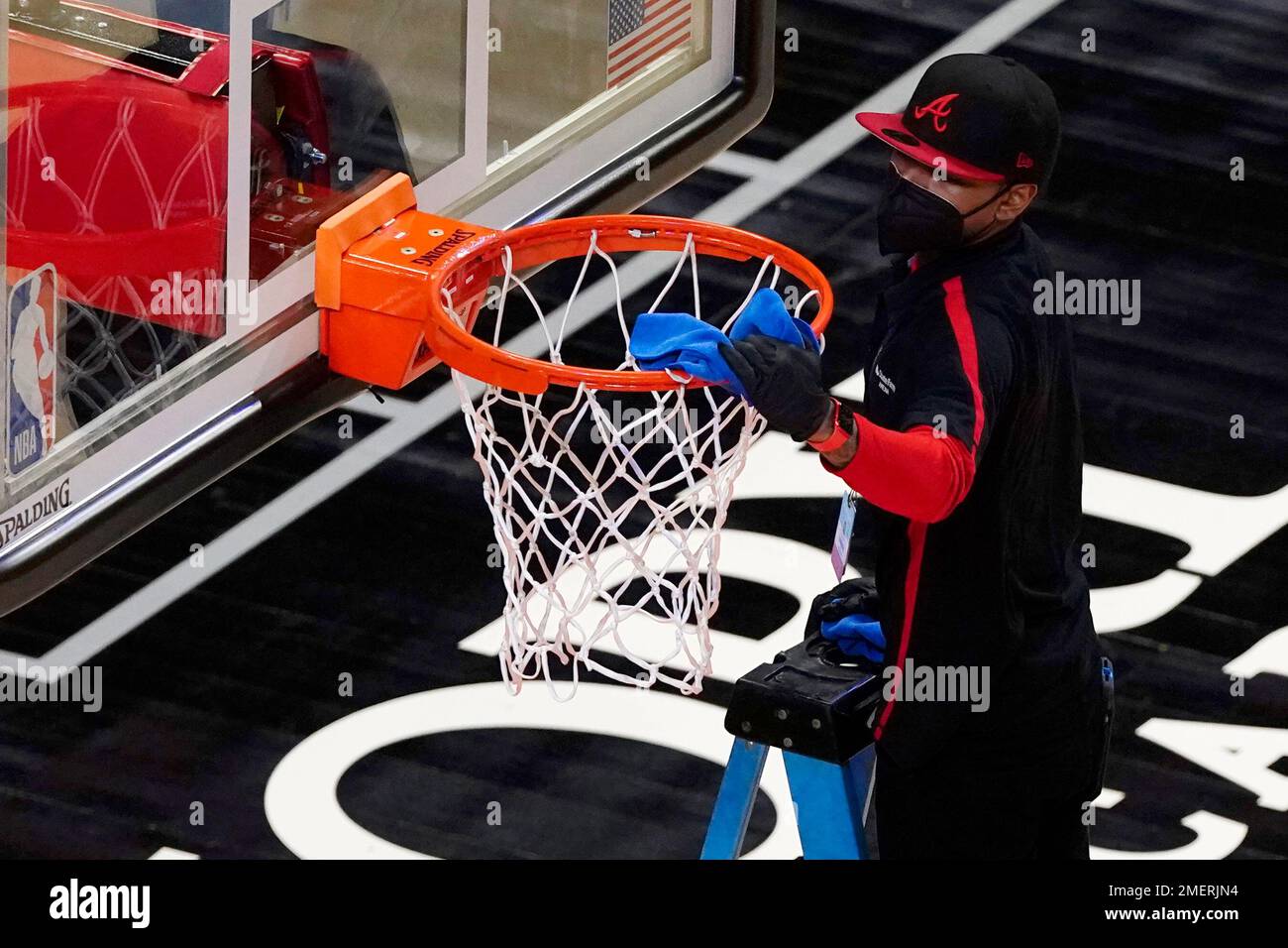 The nets, rims and backboards are cleaned during halftime of an NBA
