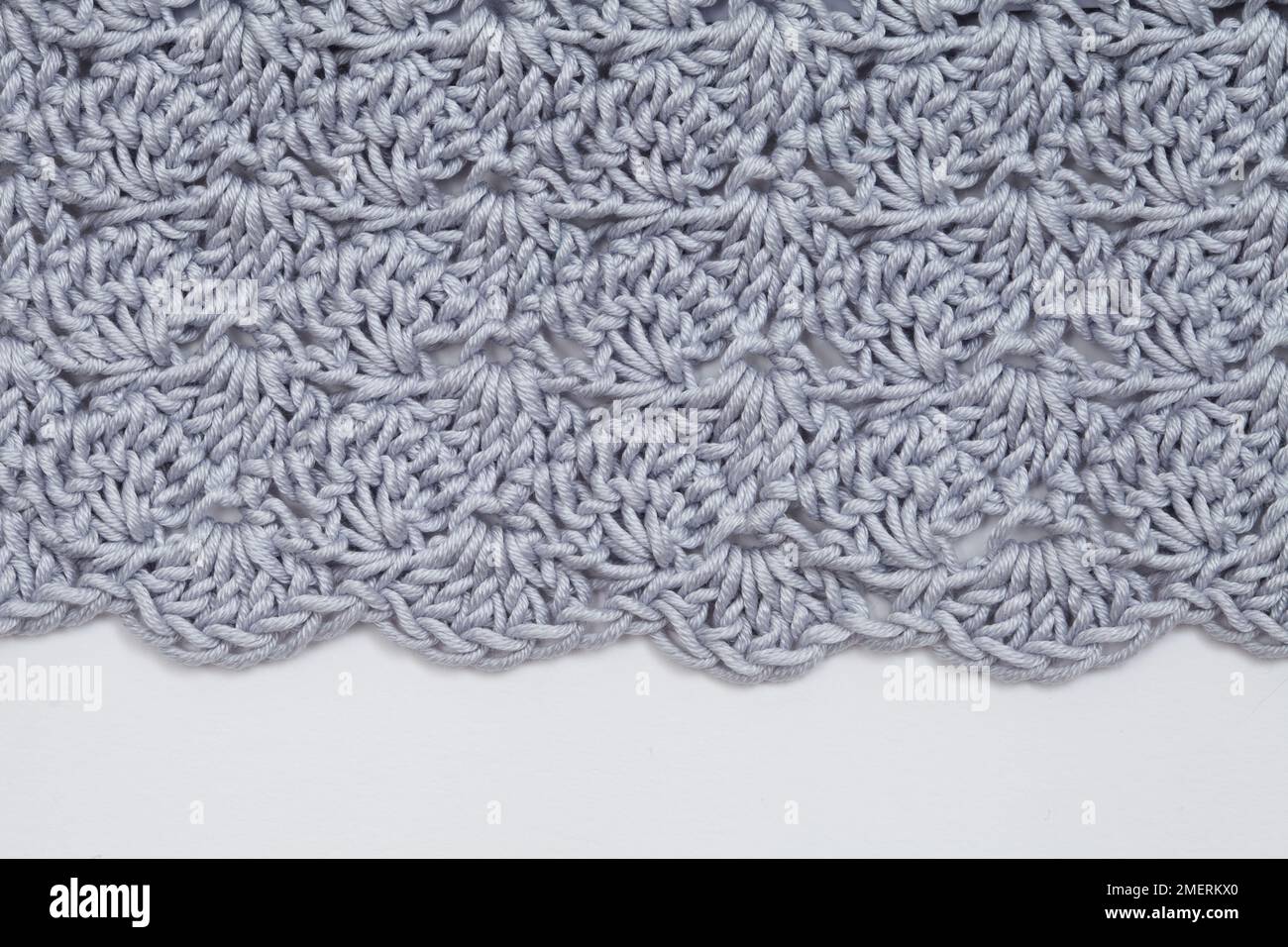 Clutch bag crocheted in cluster and shell stitch pattern, decorative edge detail Stock Photo