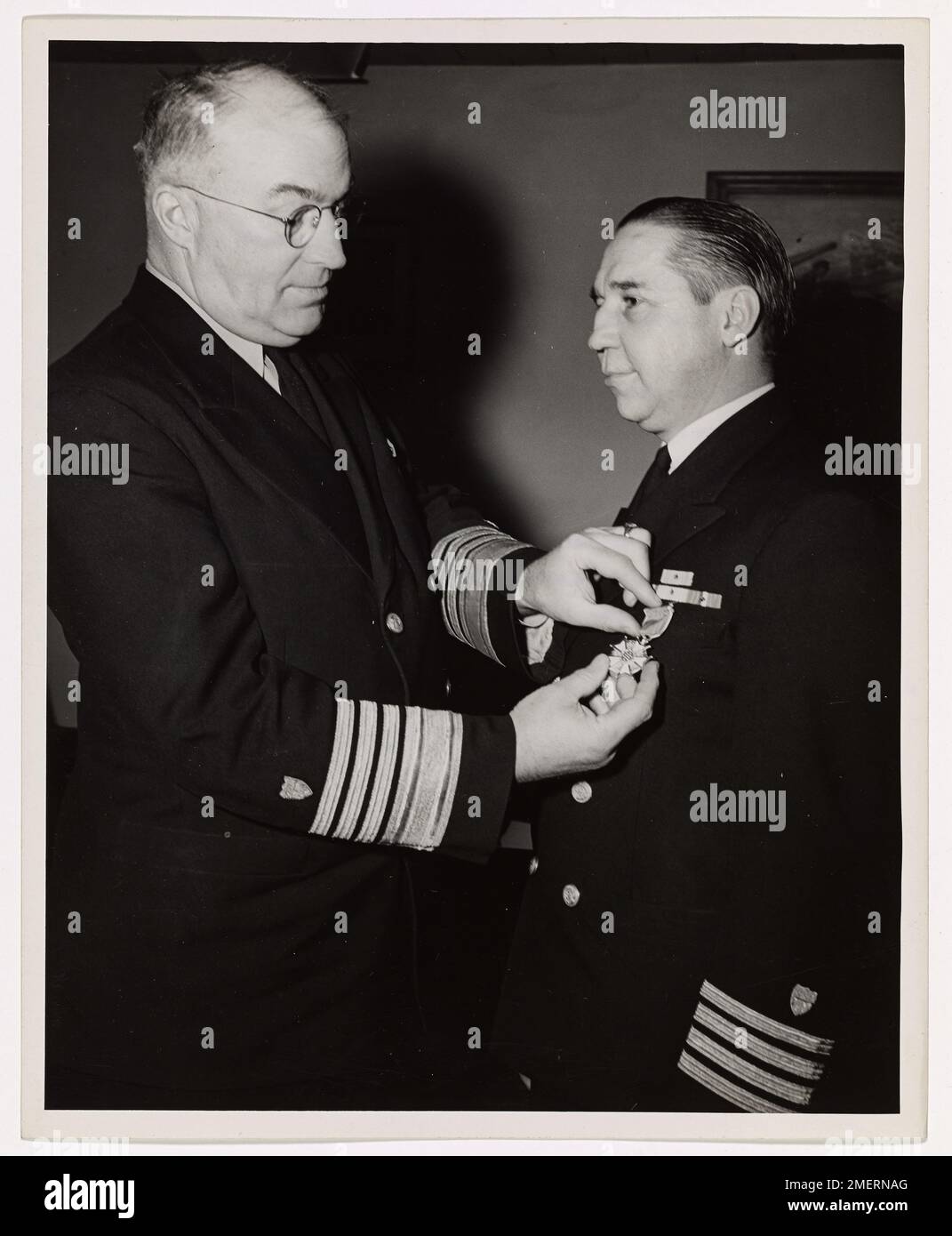 Captain Frank T. Kenner, U.S. Coast Guard, was awarded the Legion of Merit for his outstanding service in New Guinea and the Philippines. He led the operation of over 200 Army vessels and provided crucial support during WWII campaigns. Stock Photo