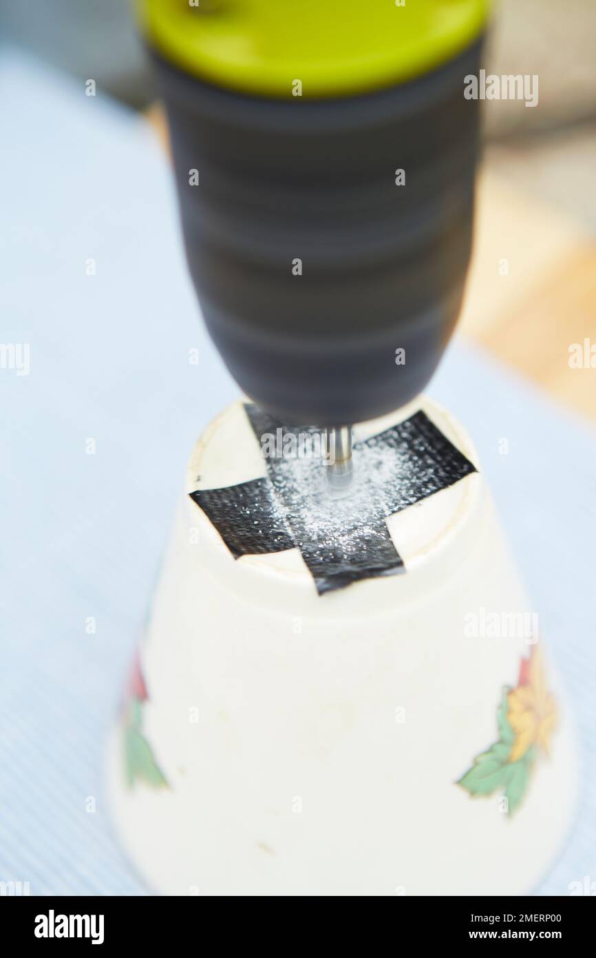 Tea cup planter, drilling a drainage hole in bottom of tea cup Stock
