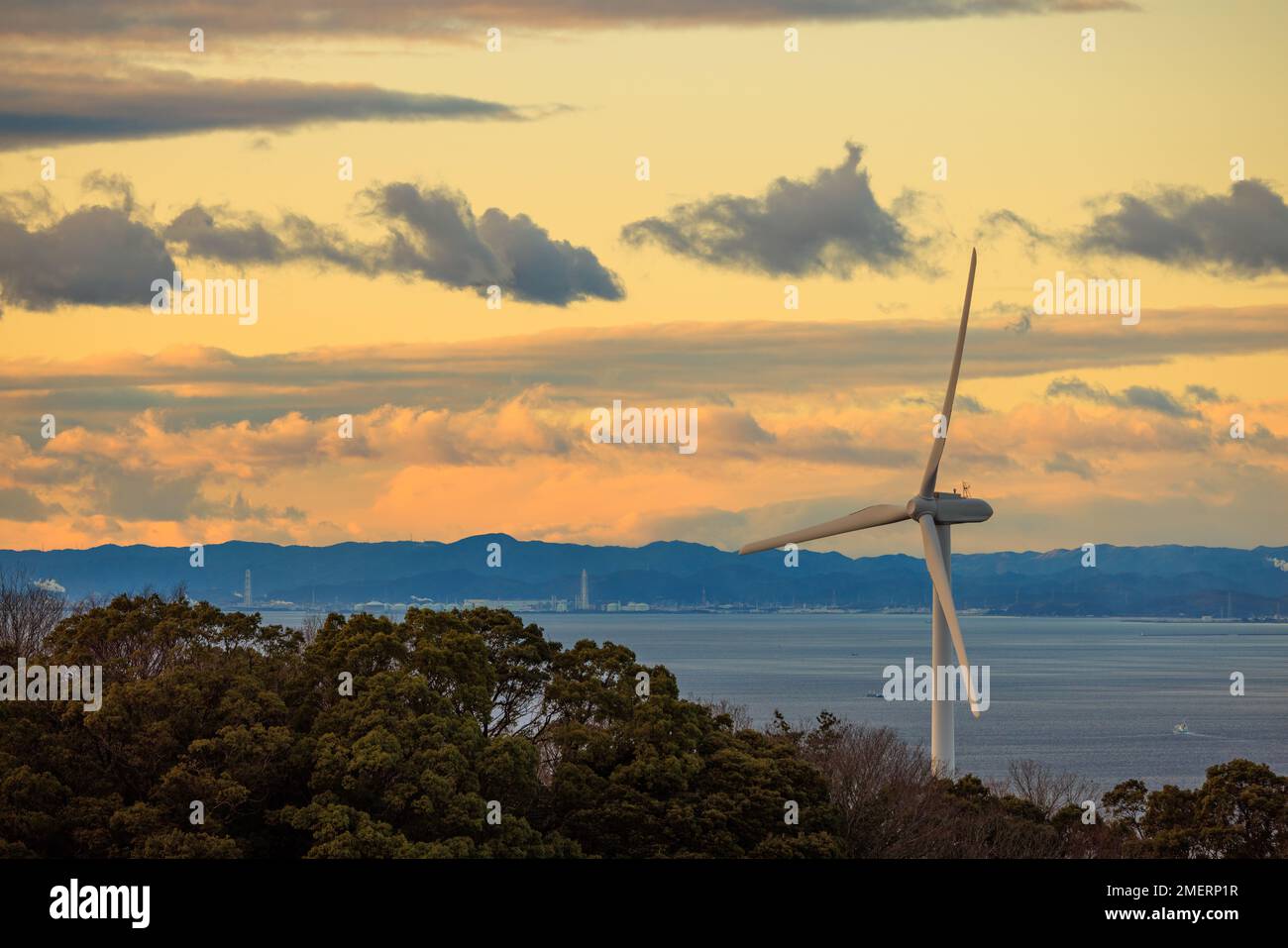 Coastal Wind Turbine with Beautiful Sunset Sky in Background Stock