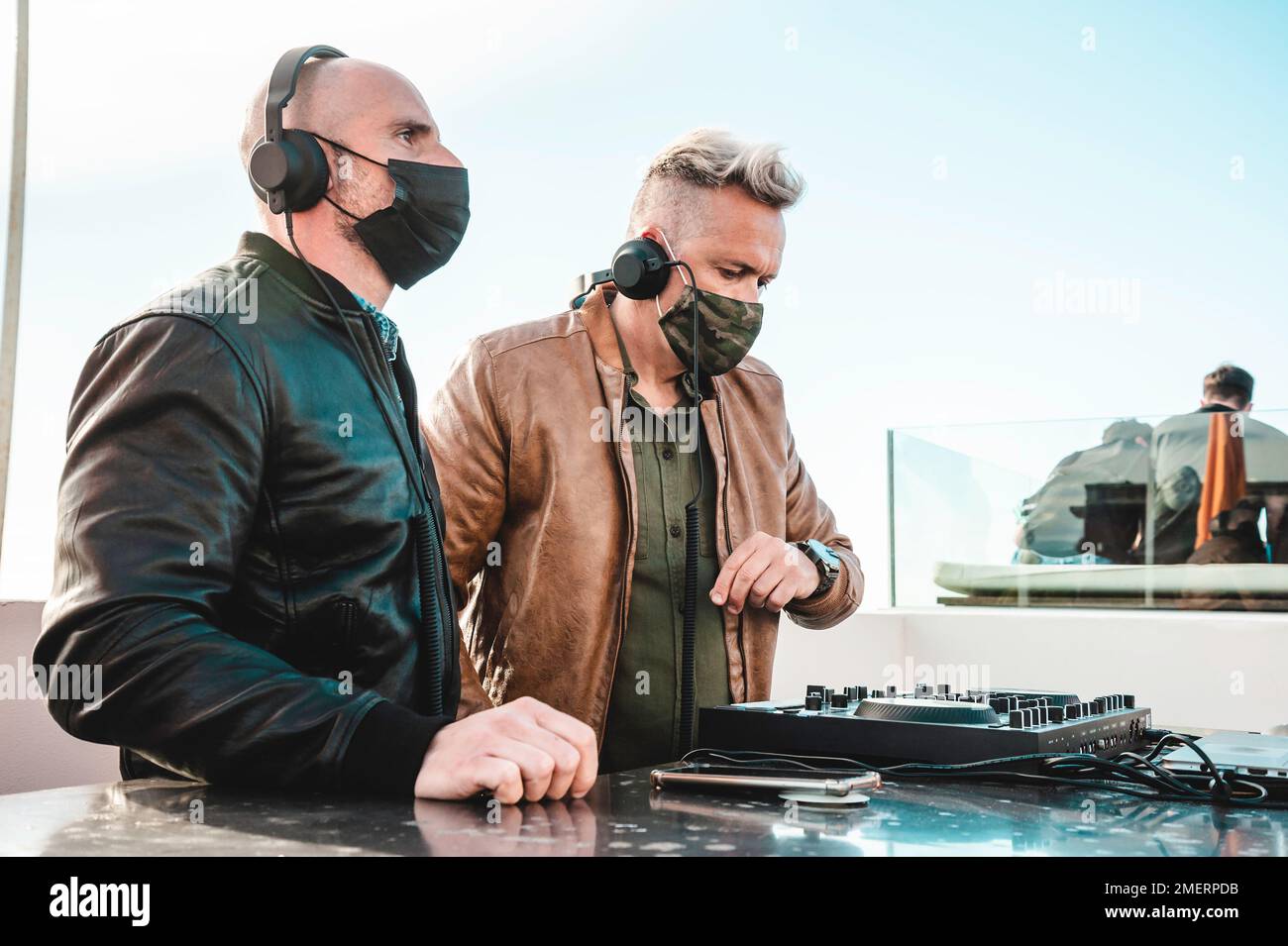 Disc jockeys playing music for tourist people at club party outdoor