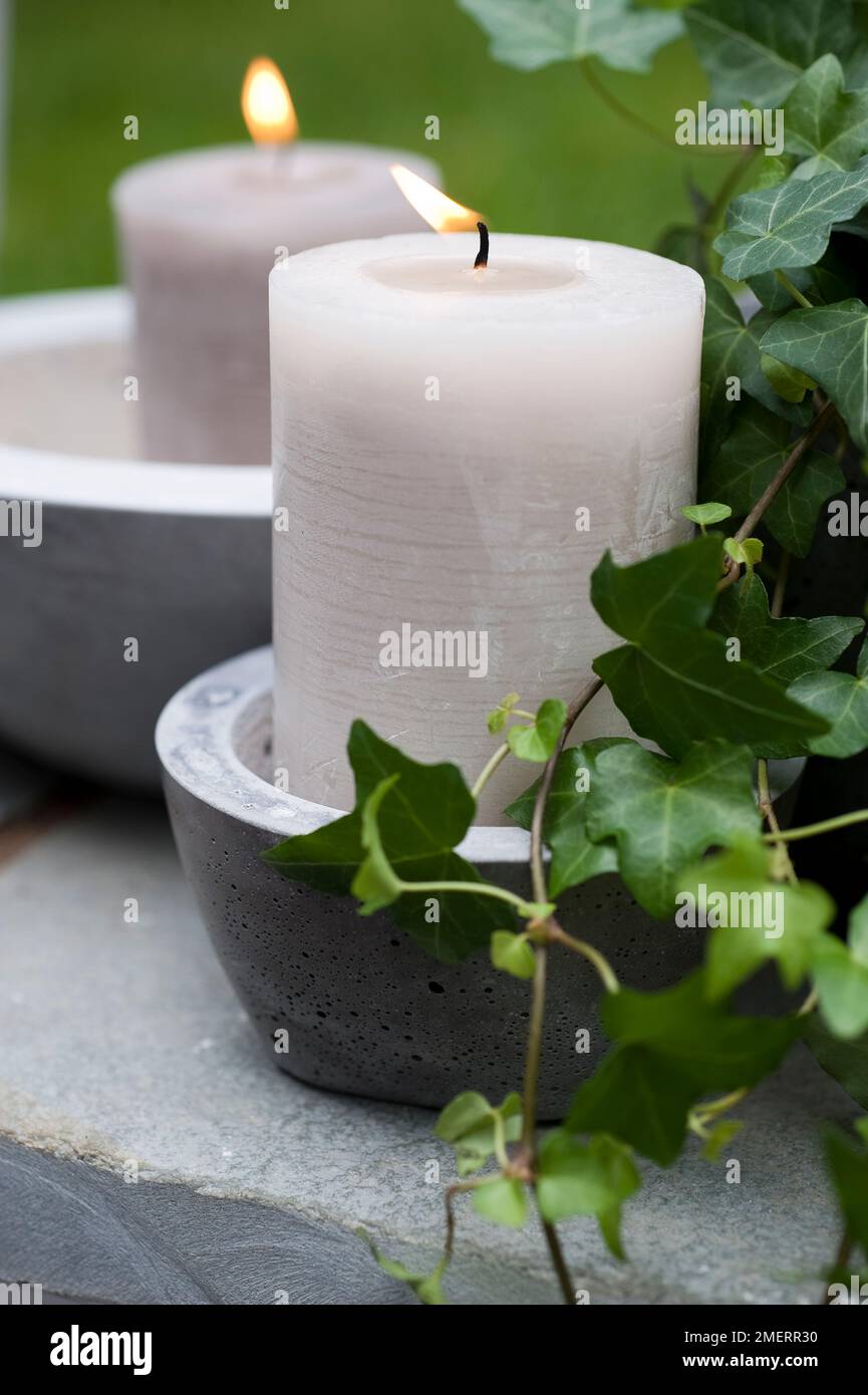 Concrete pots containing candles Stock Photo