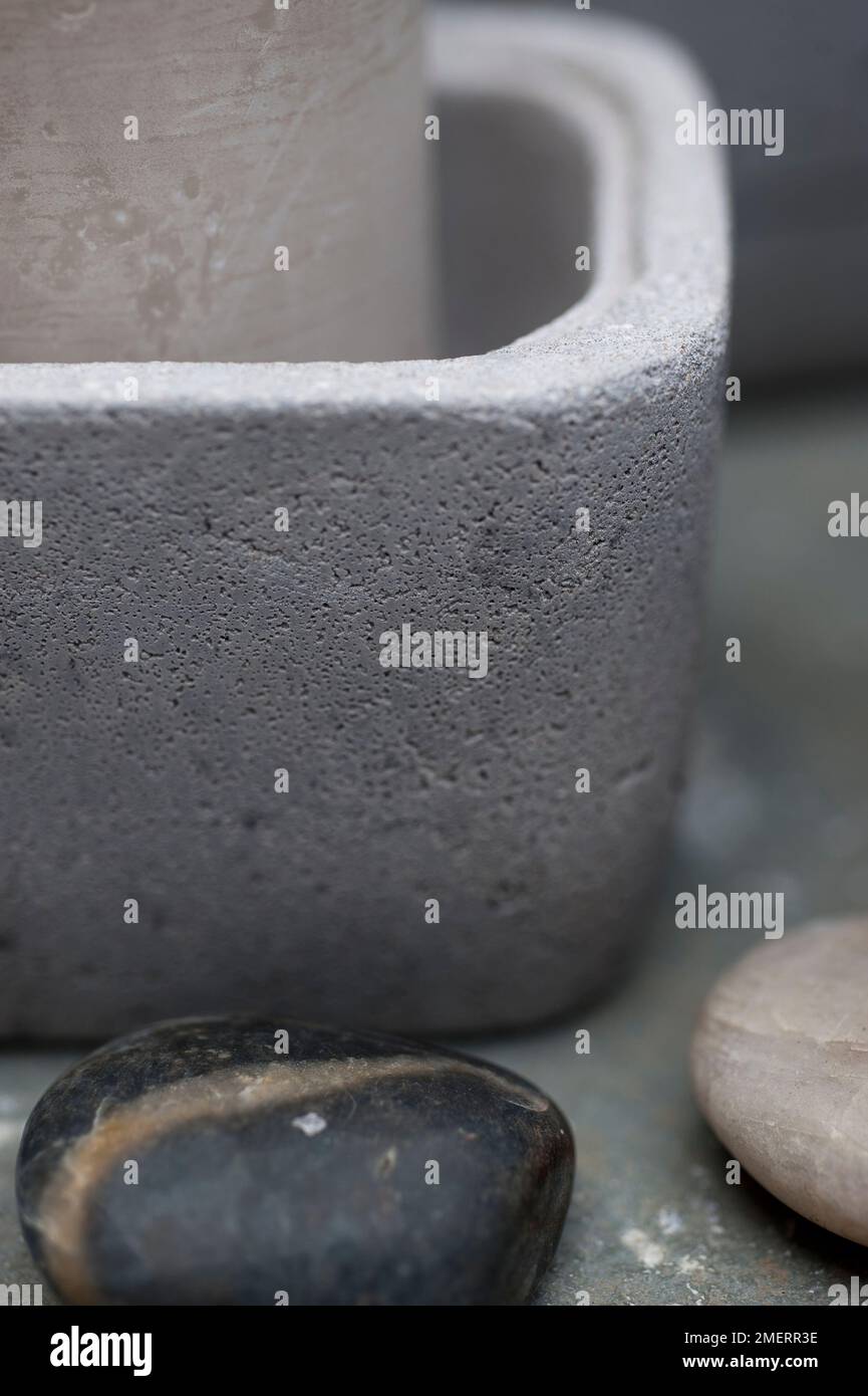 Candle in concrete bowl, close up Stock Photo