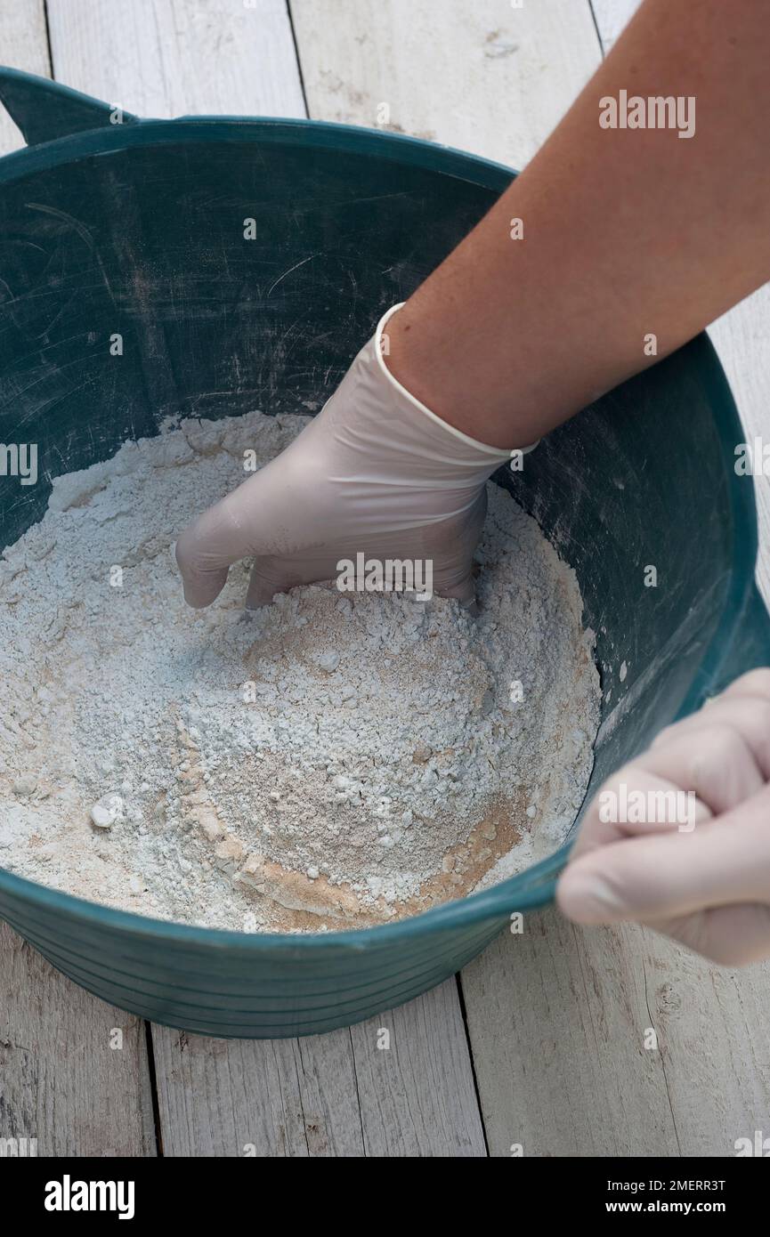 Making concrete planter, mixing together dry ingredients, cement and