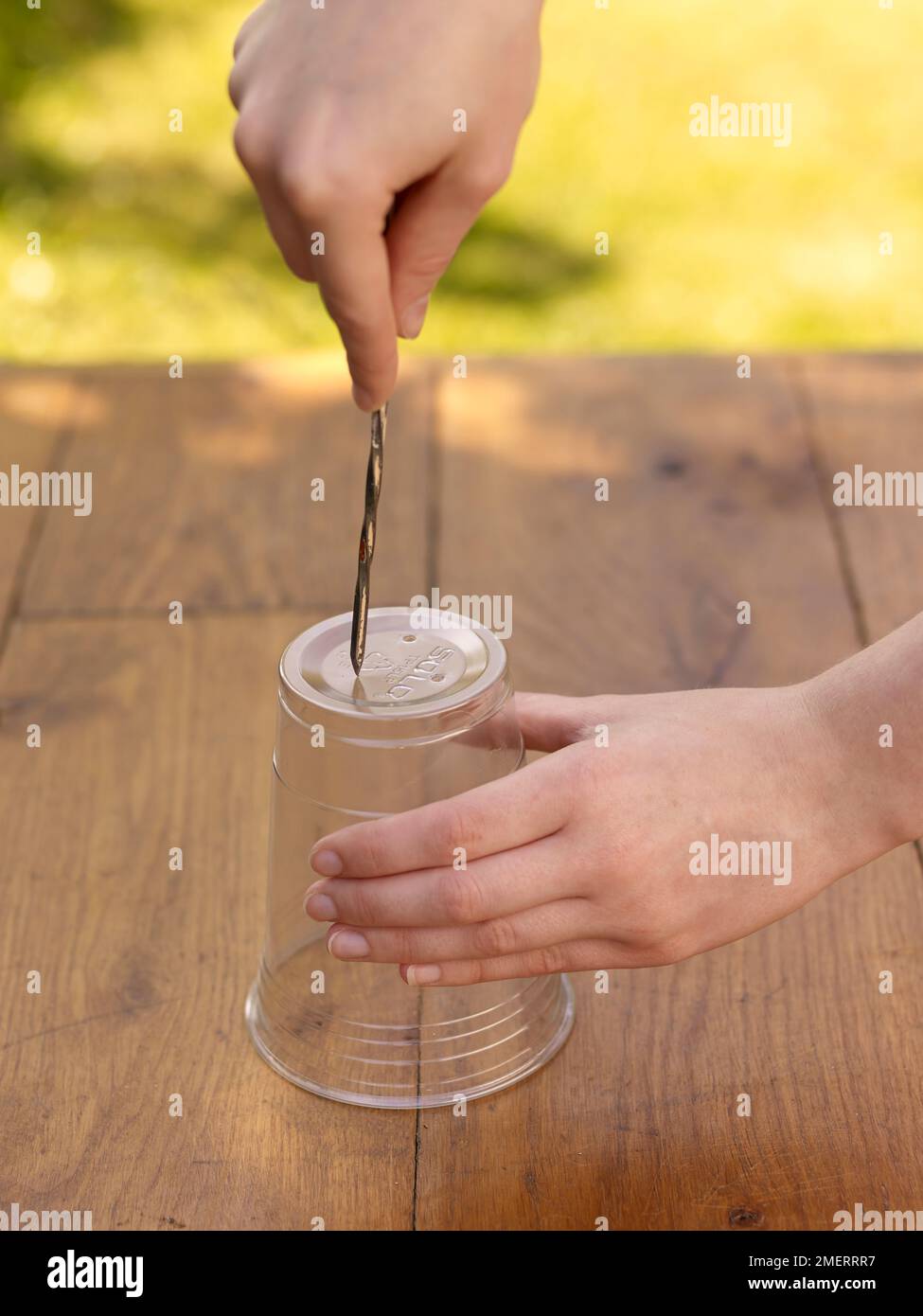 Making holes in bottom of plastic pot Stock Photo Alamy
