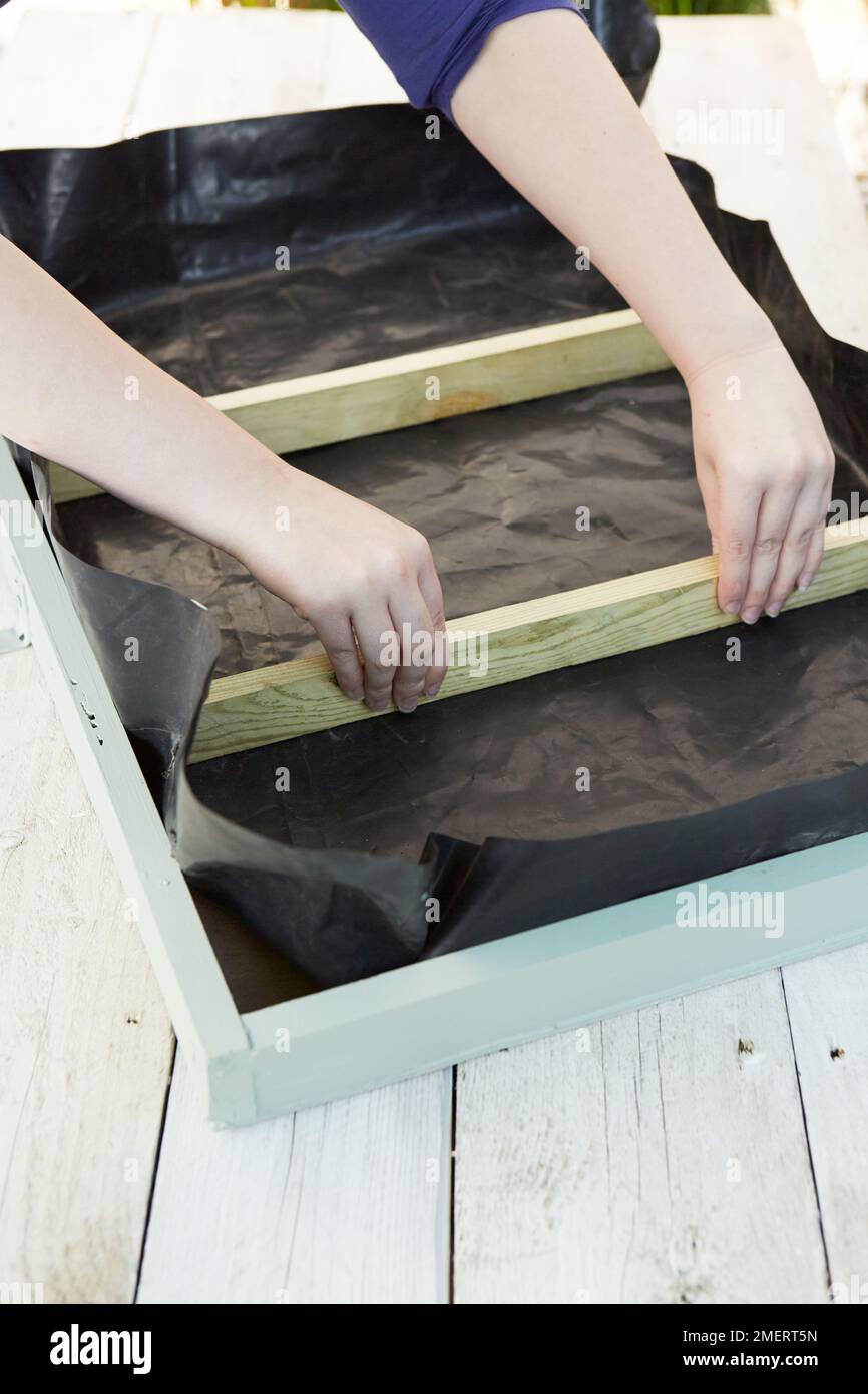 Securing batons inside living picture frame Stock Photo - Alamy